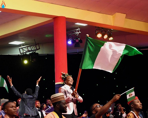 Apostle Achudume waiving the Nigeria's national flag